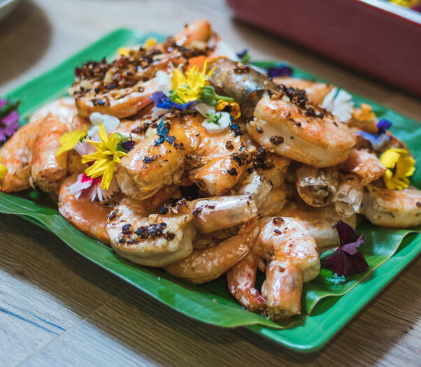 Grilled prawns served on banana leaf.