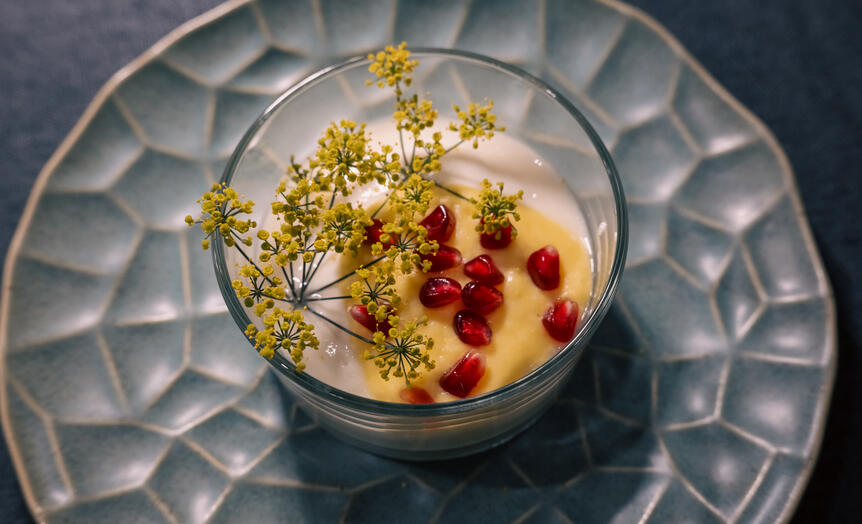 Scallop mousseline with sweet corn, pomegranate and bronze fennel flowers.